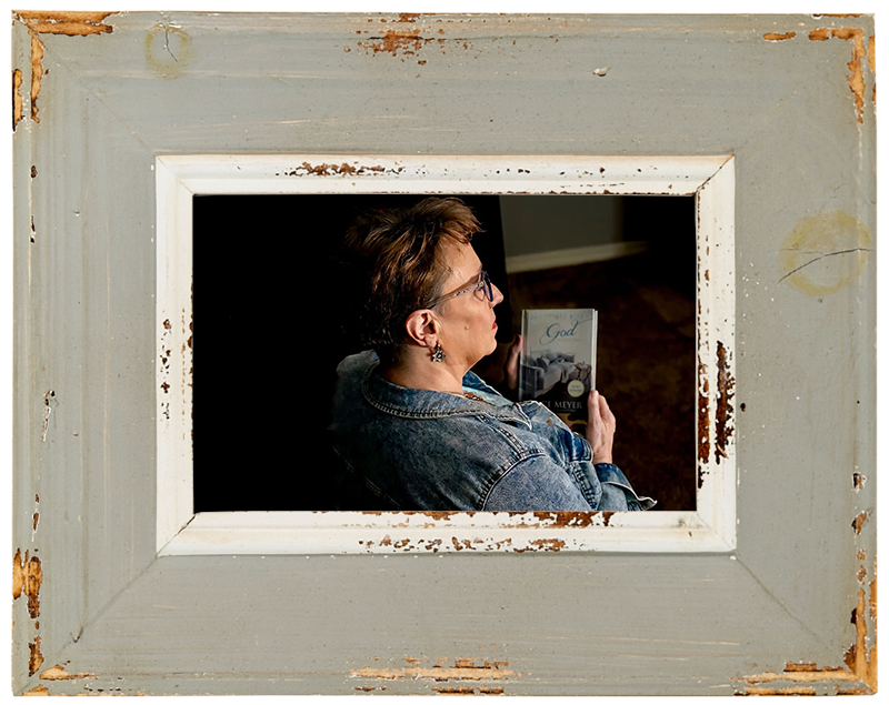 A photo taken over Coach Delisa's shoulder at a book she is holding